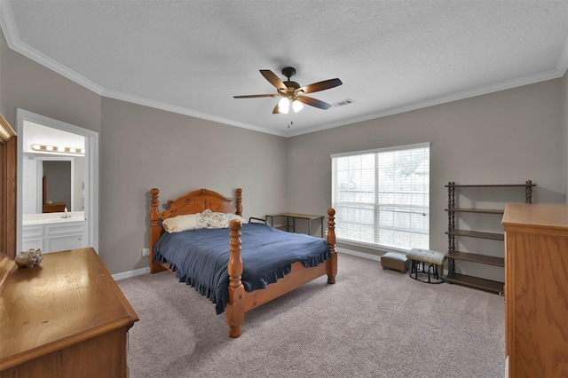 bedroom featuring ceiling fan, connected bathroom, light colored carpet, a textured ceiling, and ornamental molding