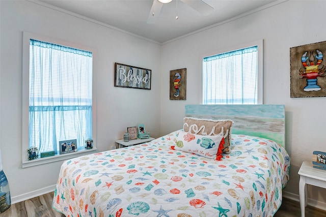 bedroom with ceiling fan, multiple windows, hardwood / wood-style floors, and ornamental molding