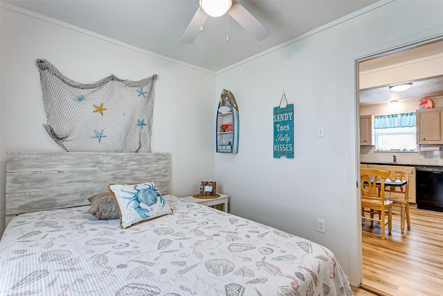 bedroom featuring ceiling fan, sink, ornamental molding, and light hardwood / wood-style flooring