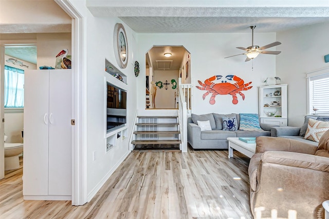 living room featuring ceiling fan and light hardwood / wood-style flooring