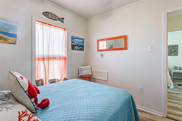 bedroom featuring wood-type flooring and crown molding