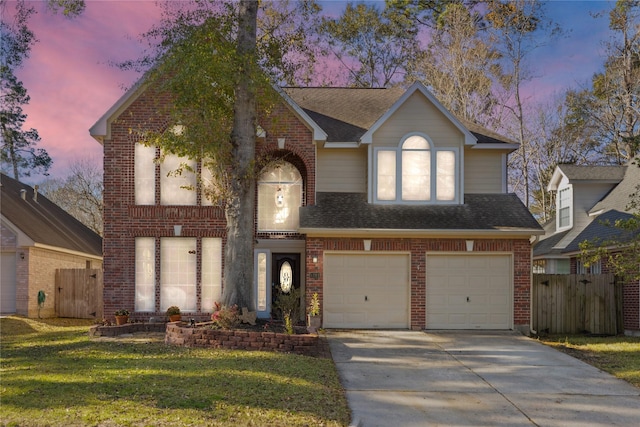 view of front of property with a garage and a lawn