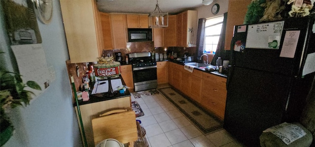 kitchen featuring light tile patterned flooring, pendant lighting, and black appliances