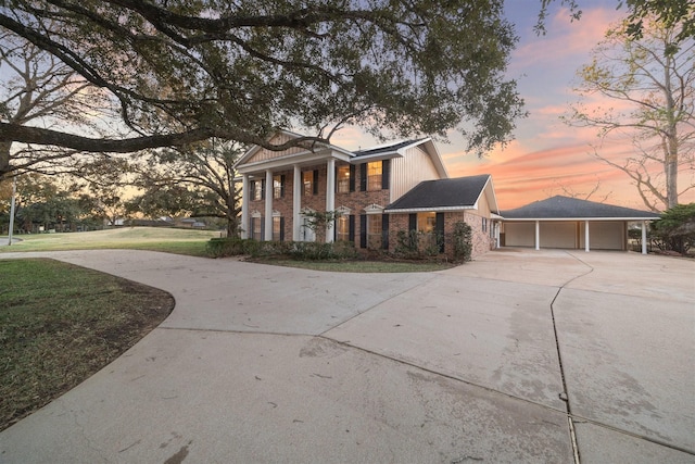 neoclassical / greek revival house featuring a yard and a garage