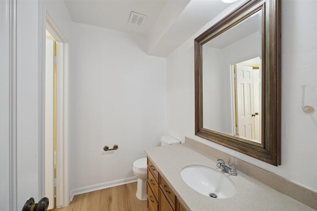 bathroom featuring hardwood / wood-style flooring, vanity, and toilet