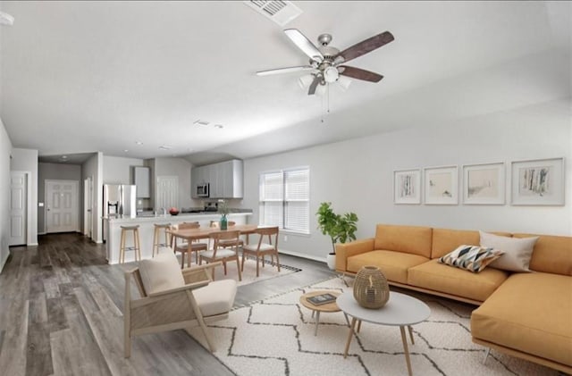 living room featuring ceiling fan and light hardwood / wood-style floors