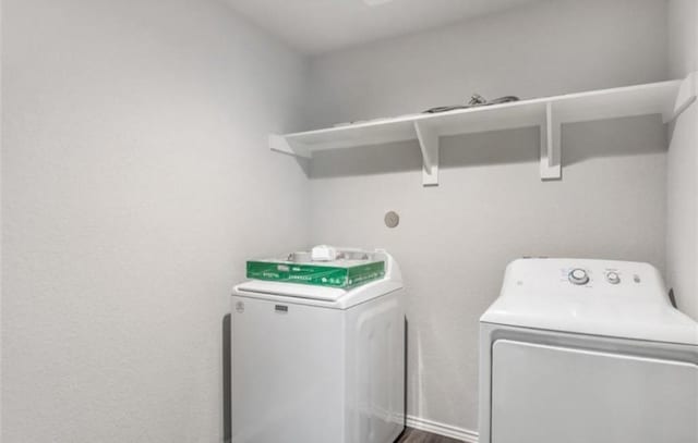 laundry room featuring washing machine and clothes dryer