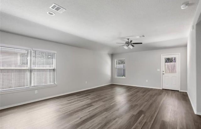 unfurnished room featuring ceiling fan and dark hardwood / wood-style flooring