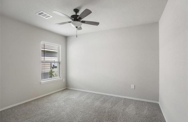 carpeted spare room with ceiling fan