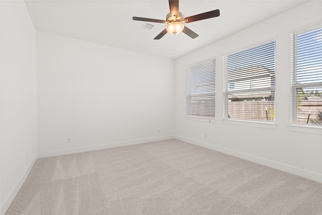 carpeted spare room featuring ceiling fan