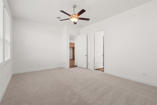 carpeted spare room with ceiling fan