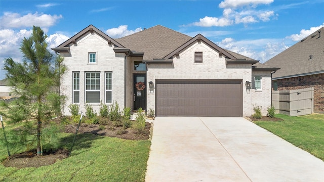 view of front of home featuring a front lawn and a garage