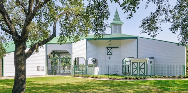 rear view of property with a yard