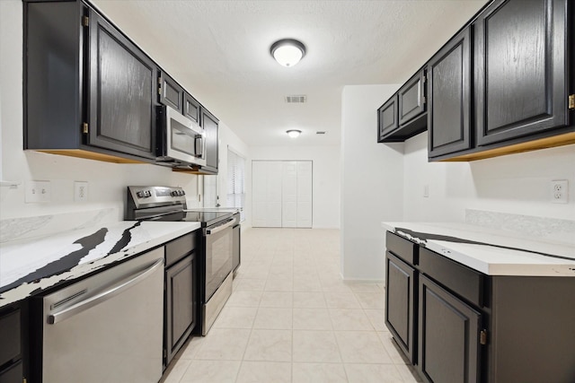 kitchen featuring light tile patterned floors and appliances with stainless steel finishes