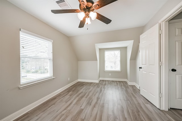 bonus room with ceiling fan, light hardwood / wood-style flooring, and vaulted ceiling