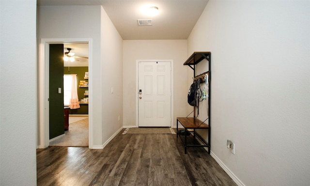 interior space featuring dark wood-type flooring and ceiling fan