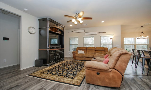 living room with dark hardwood / wood-style floors and ceiling fan with notable chandelier