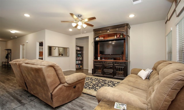 living room featuring ceiling fan and dark hardwood / wood-style floors