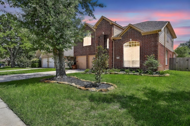 view of front facade featuring a garage and a lawn