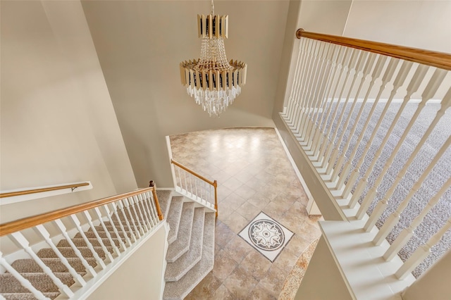 stairs with an inviting chandelier