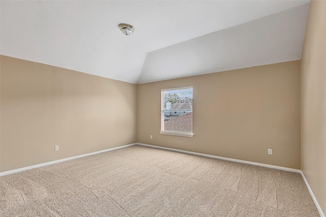 empty room with lofted ceiling and carpet floors