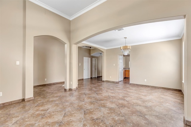 spare room with crown molding and a chandelier