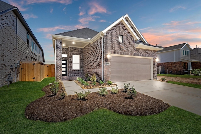 21514 Witham Promenade Ln, Magnolia, TX 77355 - view of front of property featuring driveway, fence, brick siding, a front lawn, and a garage