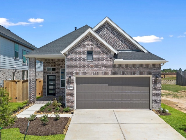 21514 Witham Promenade Ln, Magnolia, TX 77355 - view of front facade with brick siding, driveway, an attached garage, and fence