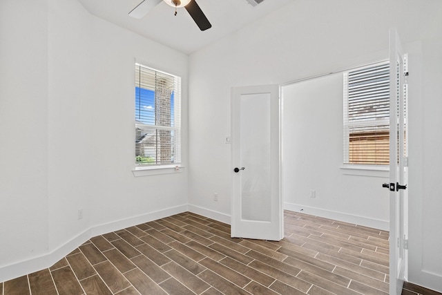 21514 Witham Promenade Ln, Magnolia, TX 77355 - spare room featuring a wealth of natural light, ceiling fan, and dark wood finished floors