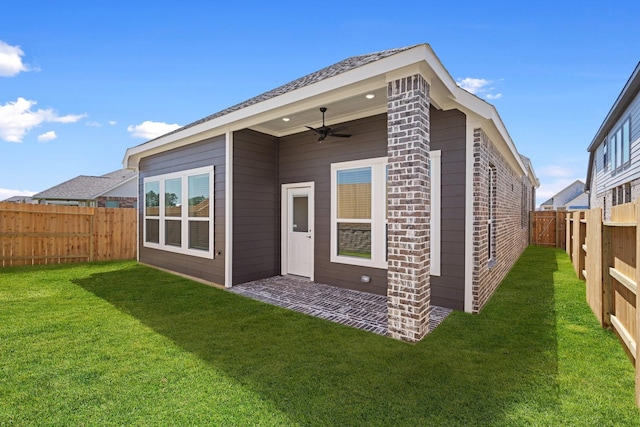 21514 Witham Promenade Ln, Magnolia, TX 77355 - back of house featuring a fenced backyard, a ceiling fan, and a yard