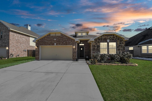 view of front facade featuring a garage and a lawn