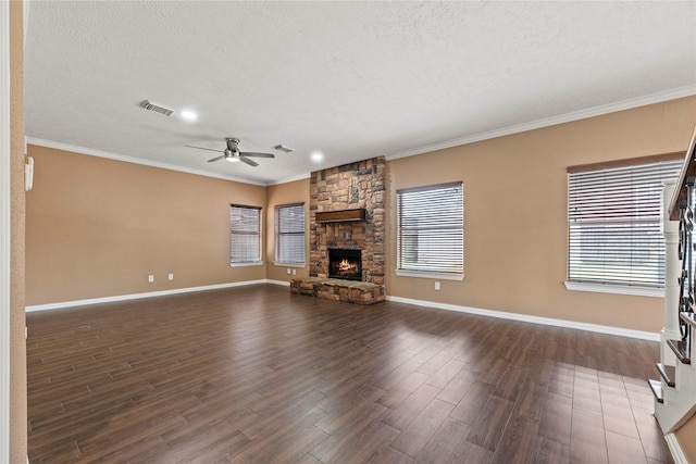 unfurnished living room featuring ceiling fan, dark hardwood / wood-style floors, crown molding, and a fireplace