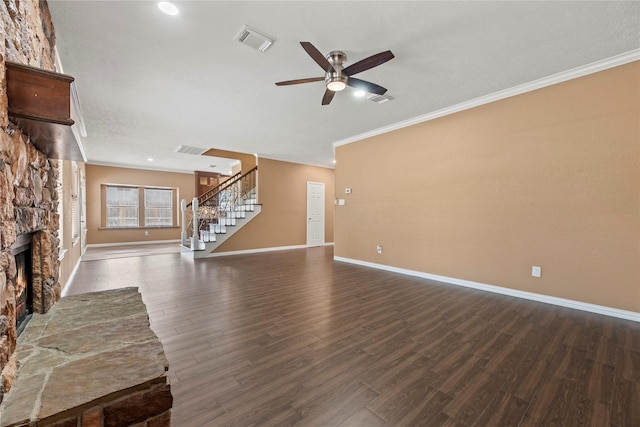 unfurnished living room with ceiling fan, dark wood-type flooring, crown molding, and a stone fireplace