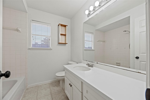 full bathroom featuring toilet, vanity, tiled shower / bath combo, and tile patterned floors