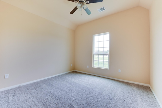 carpeted spare room featuring ceiling fan and lofted ceiling