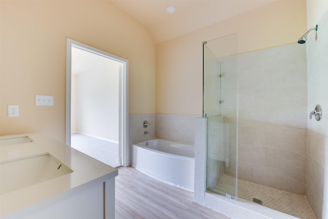 bathroom with lofted ceiling, vanity, wood-type flooring, and independent shower and bath