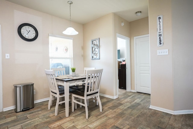 dining space with dark hardwood / wood-style flooring