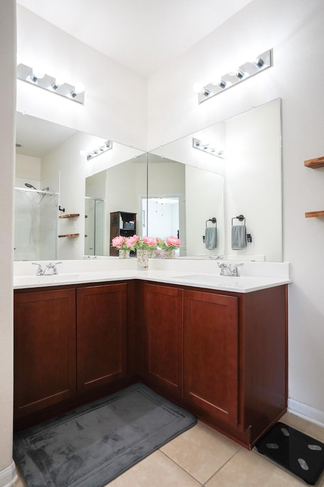 bathroom with tile patterned floors, a shower with shower door, and vanity