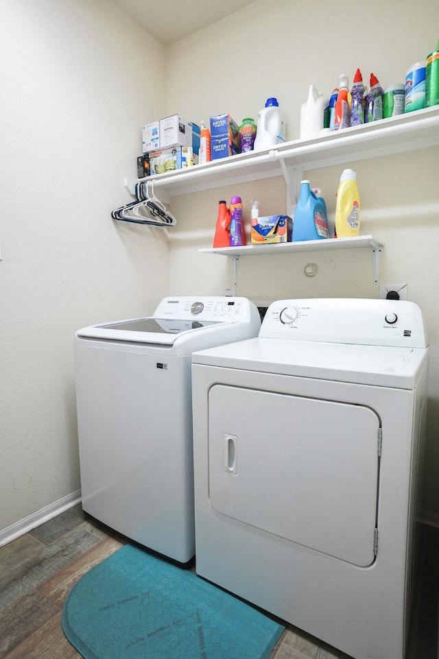 laundry room featuring dark wood-type flooring and separate washer and dryer