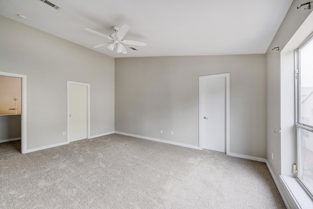 unfurnished bedroom with ceiling fan, carpet, and vaulted ceiling