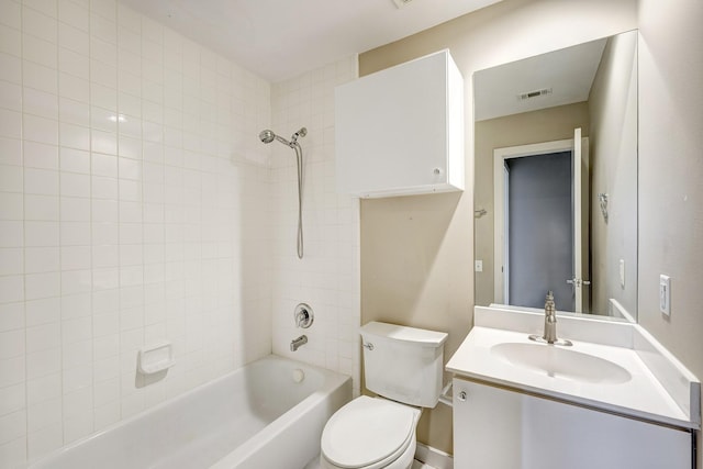 full bathroom with toilet, vanity, and tiled shower / bath