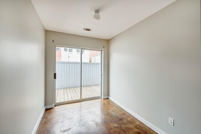 spare room with concrete floors