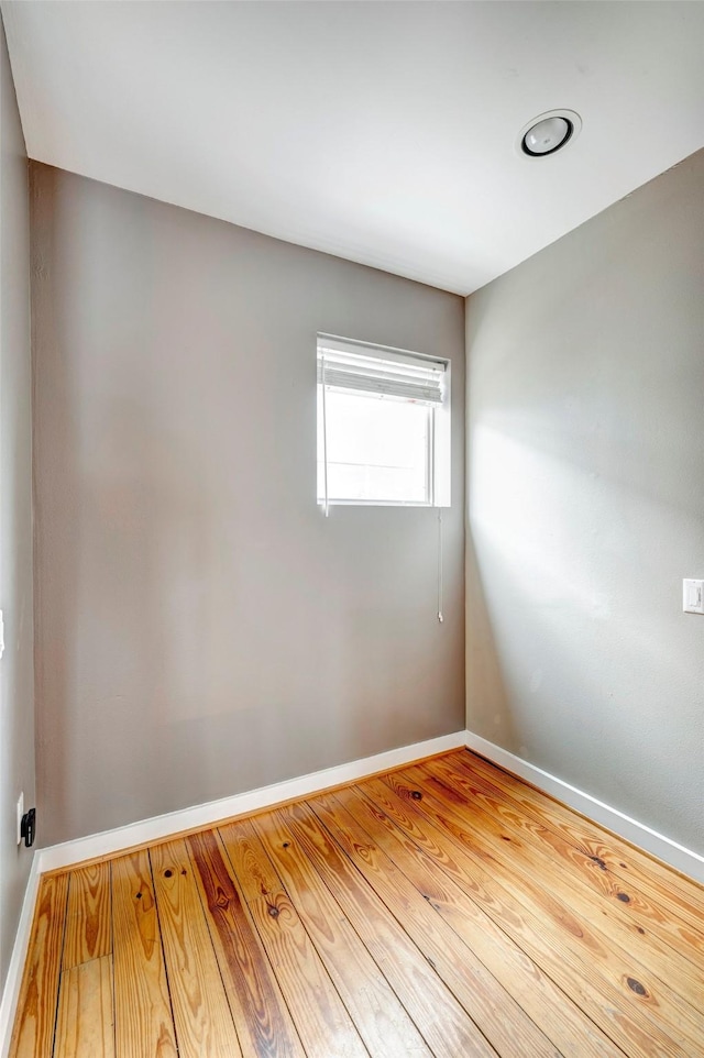 empty room with light hardwood / wood-style flooring