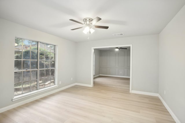 spare room with ceiling fan and light hardwood / wood-style flooring