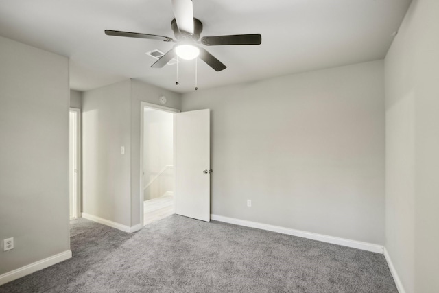 carpeted spare room featuring ceiling fan