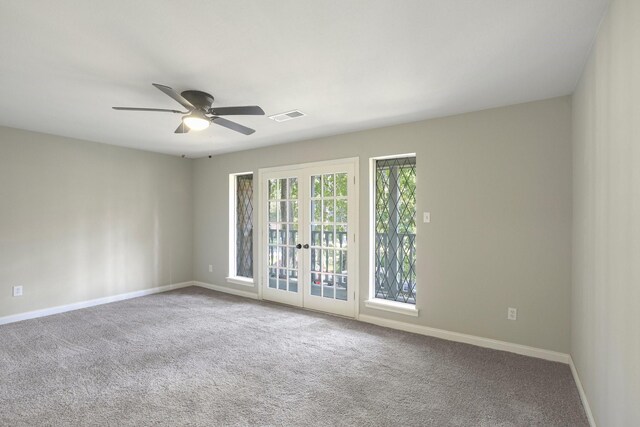 unfurnished room featuring ceiling fan, french doors, and carpet