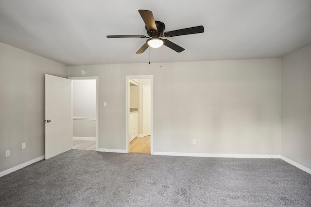 spare room with light carpet and ceiling fan