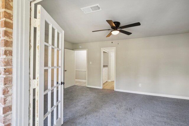 spare room featuring ceiling fan and light carpet