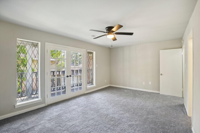 empty room featuring french doors, ceiling fan, and carpet floors