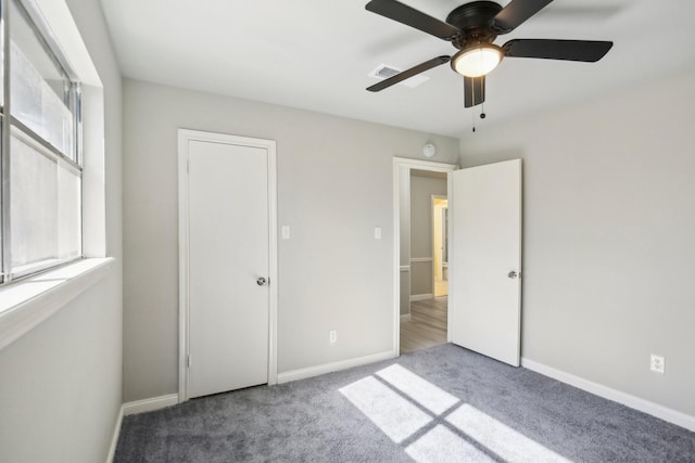 unfurnished bedroom with ceiling fan and carpet